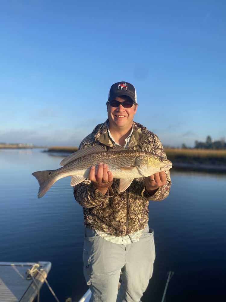 Angler holding a redfish on a winter morning