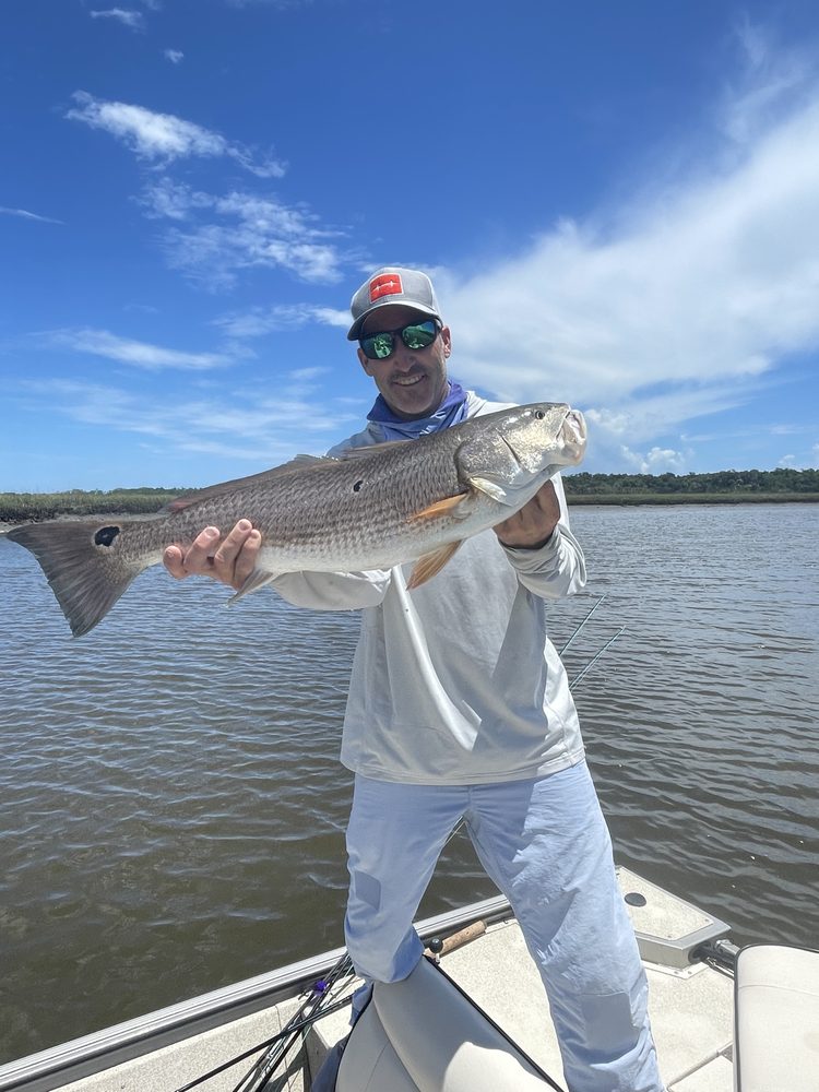 Angler holding a redfish with both hands