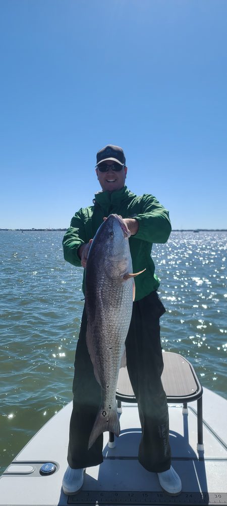 Angler holding a redfish on a cool winter day